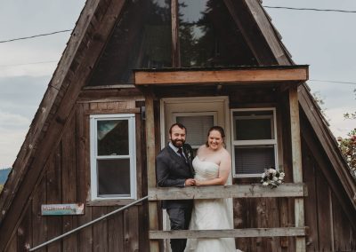 Bride and Groom on the porch of Woodpecker our A frame cabin