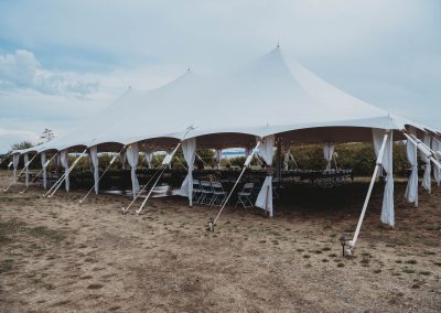 Rental tent with drapery sits on the lawn just outside the lodge ready for a wedding reception
